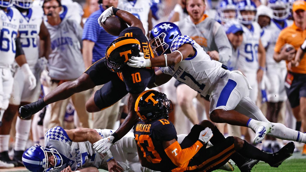 Tennessee linebacker Juwan Mitchell (10) is tackled by Kentucky running back JuTahn McClain (17) after an interception during the first half of an NCAA college football game Saturday, Oct. 29, 2022, in Knoxville, Tenn. (AP Photo/Wade Payne)