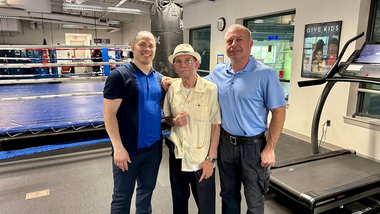 Carlos Garcia (middle) with Jose Rivera and Tom Duffy at the Worcester Boys and Girls Club (Spectrum News1/Kevin Shea)