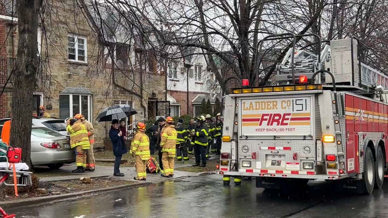 Fire personnel arrives at a residential home in Key Gardens after a fire broke out, injuring 18 children. (Spectrum News NY1)
