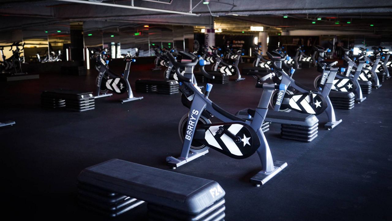 Exercises bikes and floor equipment are set up in the open-air parking garage of the Beverly Center for a RIDE class by Barry's, the boutique fitness brand founded in Los Angeles. (Photo by Benedicte Castillo)