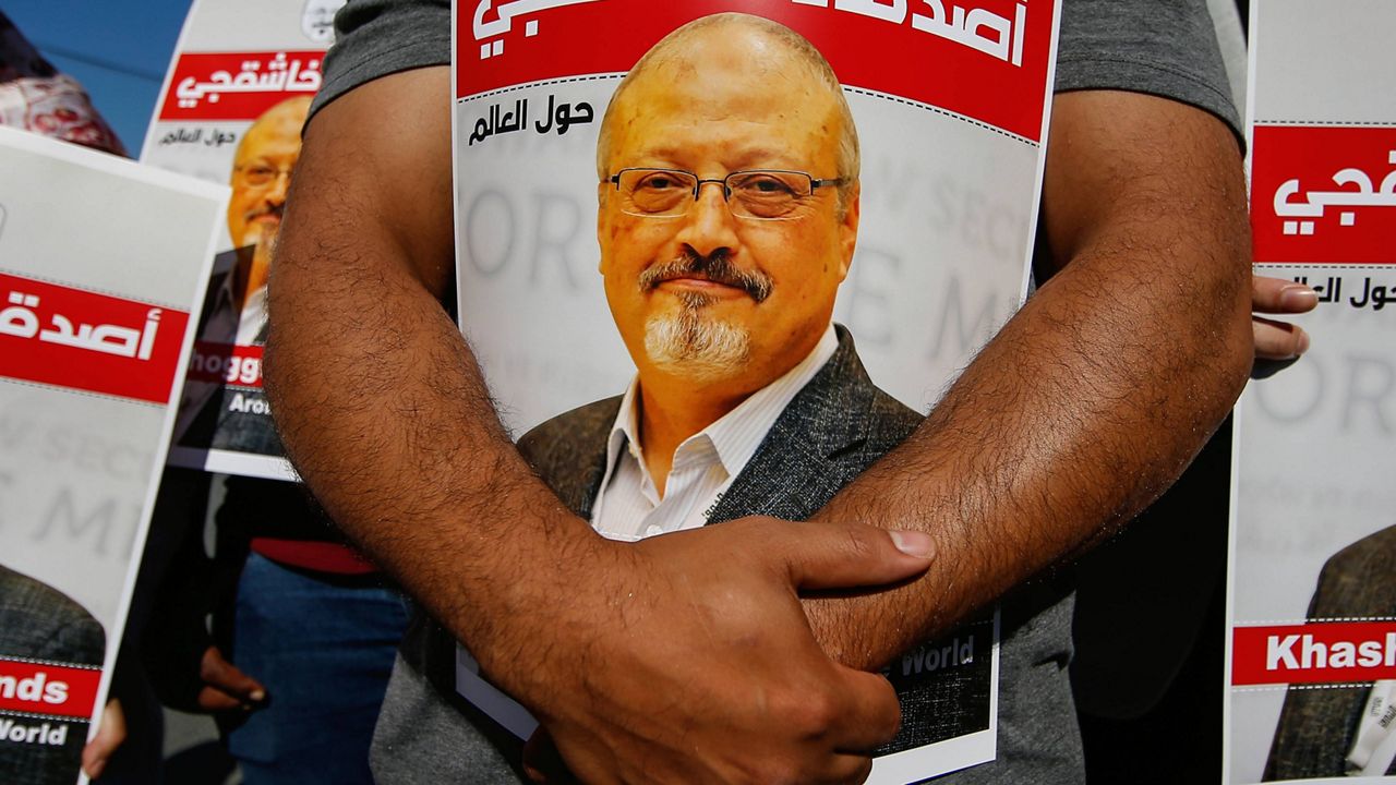 People hold posters of slain Saudi journalist Jamal Khashoggi near the Saudi Arabia consulate in Istanbul, Turkey, Oct. 2, 2020, marking the two-year anniversary of his death. (AP Photo/Emrah Gurel, File)