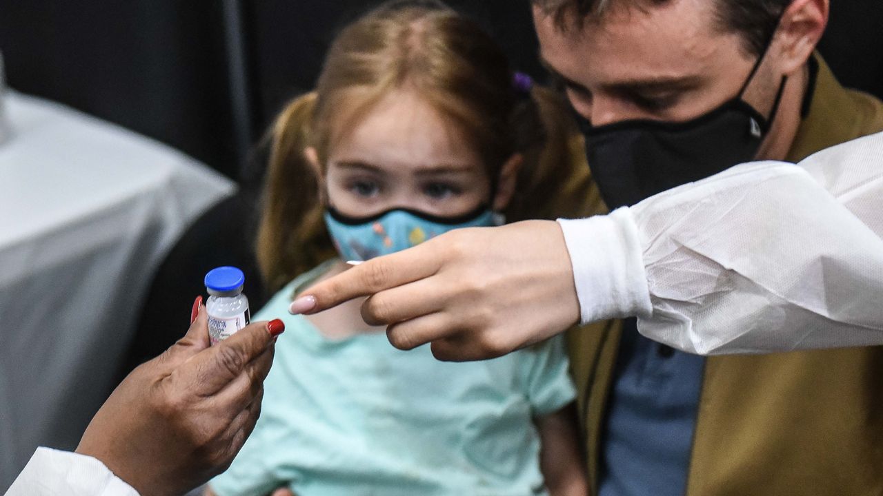 A child receives a vaccine at a city-run COVID-19 vaccination site in Times Square during a visit from Mayor Eric Adams on June 22, 2022. The Times Square location and all other vaccine sites for children under 5 will stop operating on Aug. 14. (Michael Appleton/Mayoral Photography Office)
