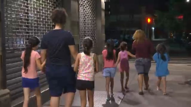 Kids on a city sidewalk.