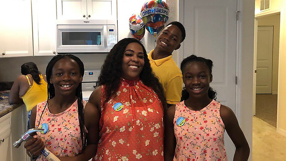 Kiera Mitchell (with her three kids) says that she's learned plenty about being a homeowner after she was accepted into the Habitat for Humanity program. (Mitch Perry/Spectrum Bay News 9)
