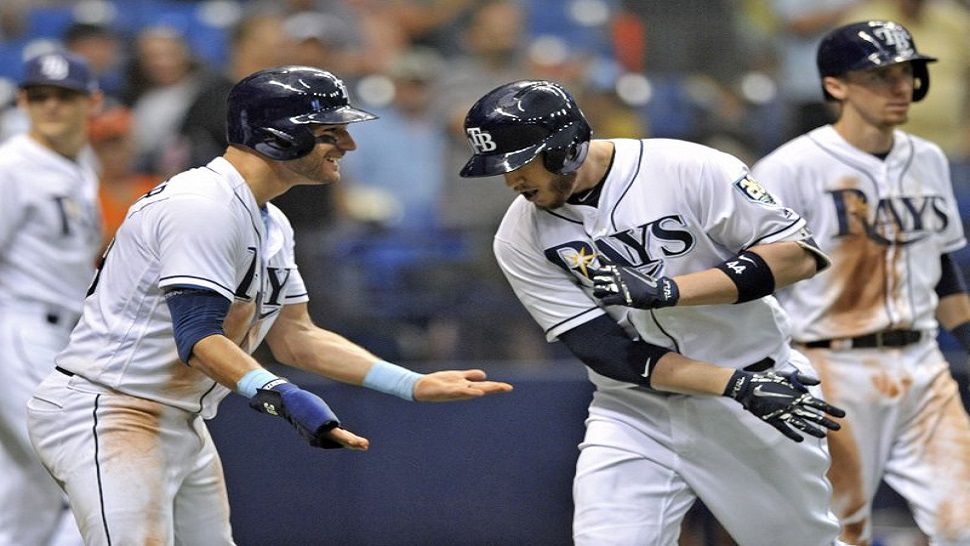 Tampa Bay Rays’ Kevin Kiermaier, left, celebrates with C.J. Cron, center, after he scored with Matt Duffy, right, on Cron’s three-run home run off Detroit Tigers’ Jordan Zimmerman during the seventh inning of a baseball game Wednesday, July 11, 2018, in St. Petersburg, Fla. (AP Photo/Steve Nesius)