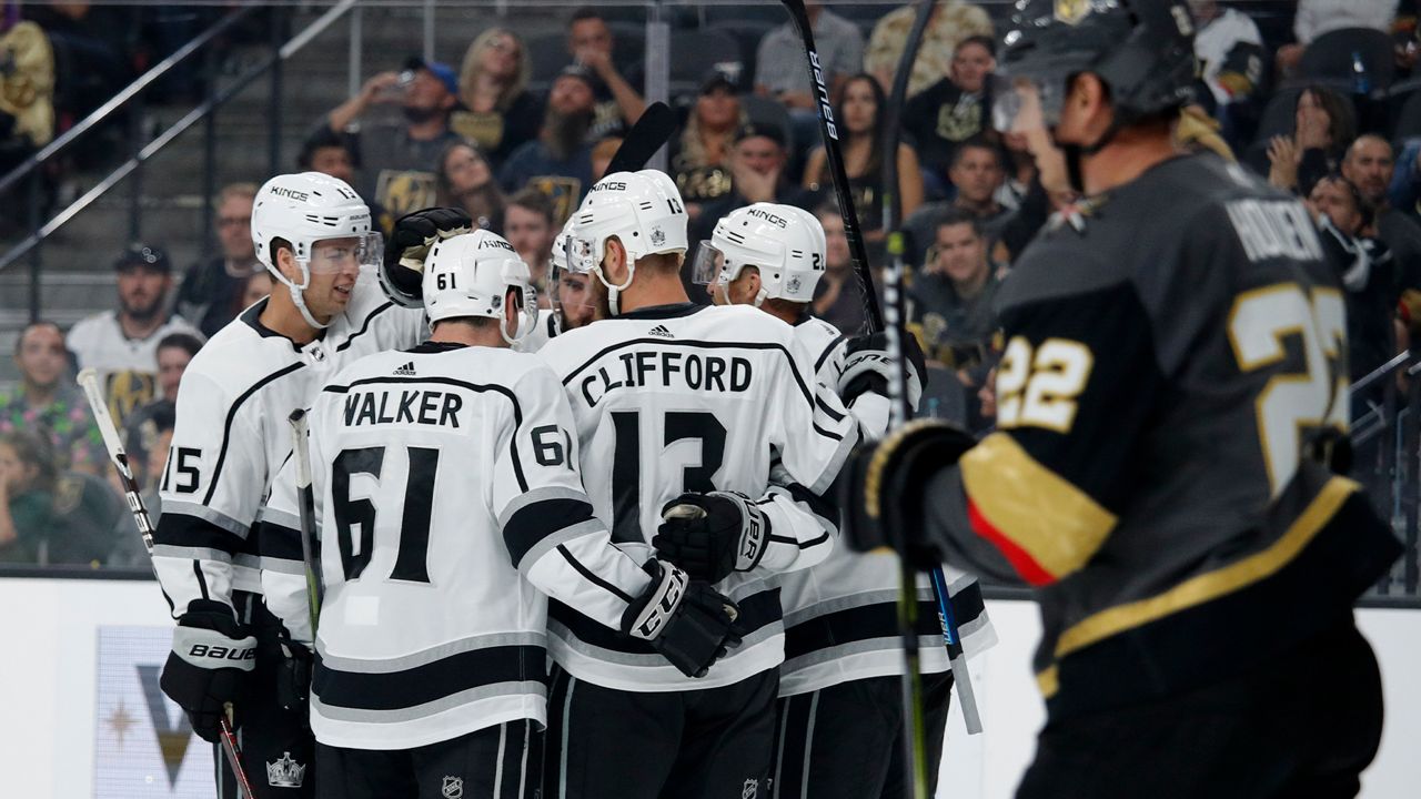 Los Angeles Kings players celebrate after left wing Kyle Clifford, second from right, scored against the Vegas Golden Knights during the third period of an NHL preseason hockey game, Friday, Sept. 27, 2019, in Las Vegas. (AP Photo/John Locher)