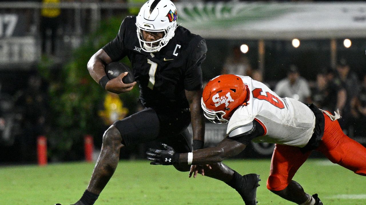 UUCF quarterback KJ Jefferson (1) scrambles for yardage as Sam Houston State linebacker Trey Fields (6) defends on Saturday, Sept. 7, 2024. (AP Photo/Phelan M. Ebenhack)