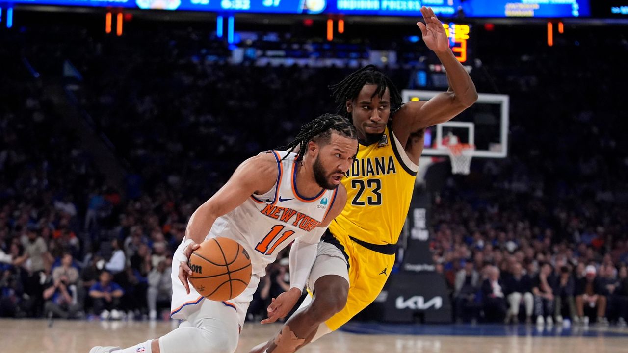 New York Knicks' Jalen Brunson (11) drives past Indiana Pacers' Aaron Nesmith (23) during the first half of Game 1 in an NBA basketball second-round playoff series, Monday, May 6, 2024, in New York. (AP Photo/Frank Franklin II)