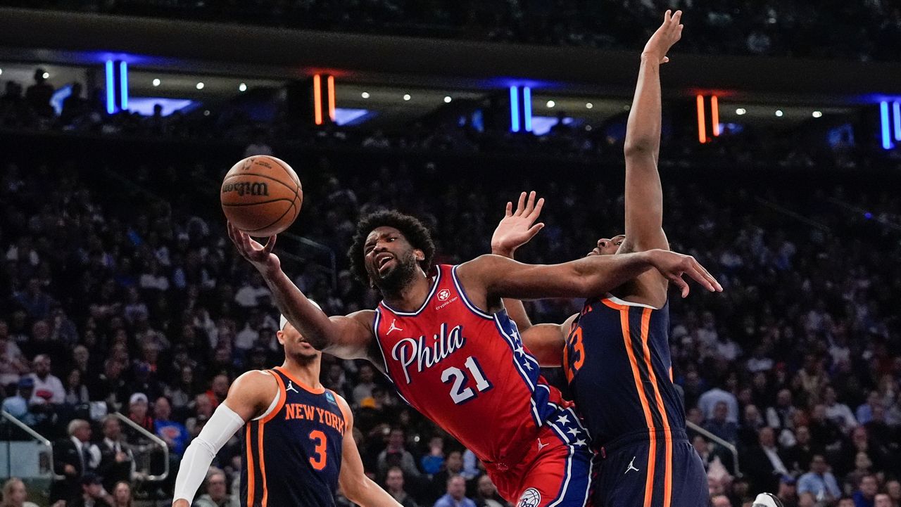 Joel Embiid drives past Mitchell Robinson and Josh Hart during a game in New York on Monday, April 22, 2024.