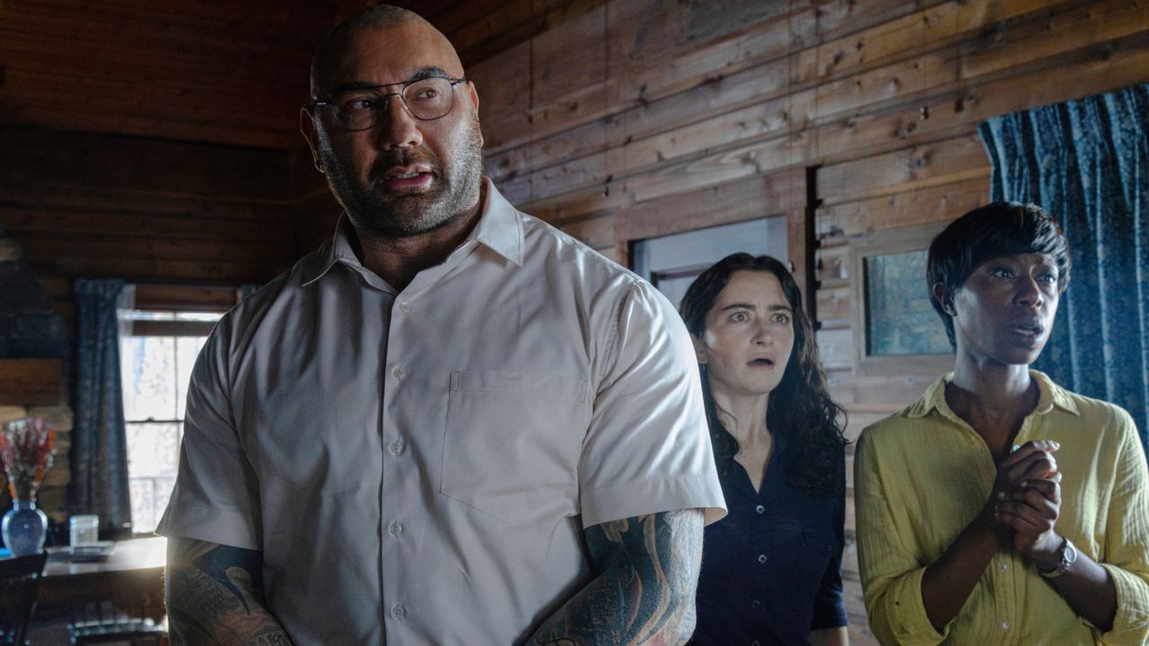 This image released by Universal Pictures shows Dave Bautista, from left, Abby Quinn, and Nikki Amuka-Bird in a scene from "Knock at the Cabin." (Universal Pictures via AP)