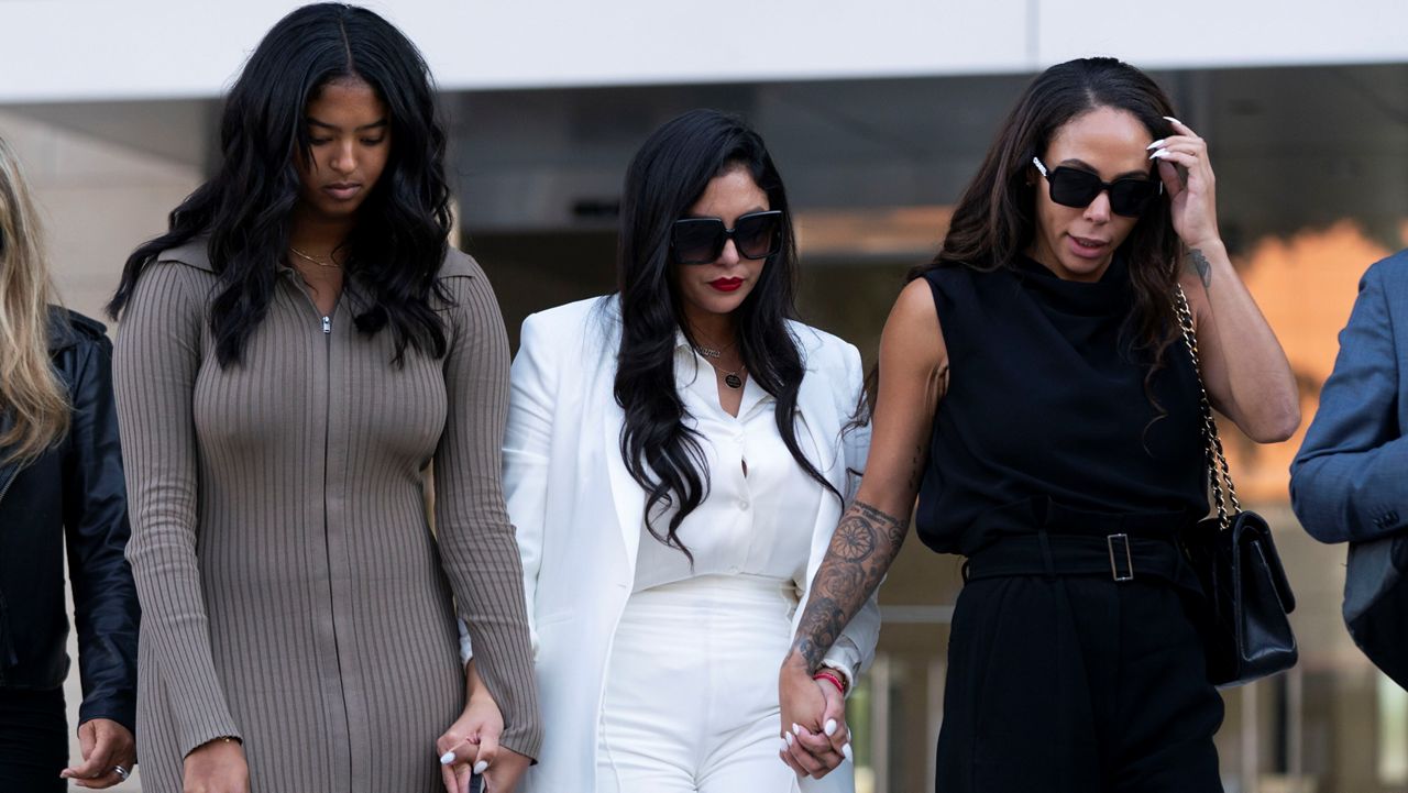 Vanessa Bryant, center, Kobe Bryant's widow, leaves a federal courthouse with her daughter, Natalia, left, and soccer player Sydney Leroux in Los Angeles, Wednesday, Aug. 24, 2022. A federal jury has found that Los Angeles County must pay Bryant's widow $16 million over photos of the NBA star's body at the site of the 2020 helicopter crash that killed him. (AP Photo/Jae C. Hong)