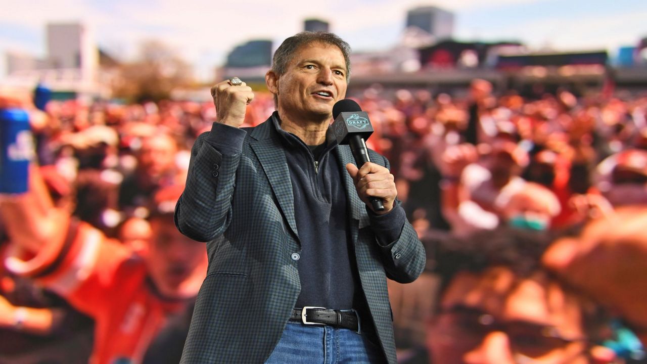Former Cleveland Browns quarterback Bernie Kosar speaks to fans during the fourth round of the NFL football draft, May 1, 2021, in Cleveland. (AP Photo/David Dermer, File)
