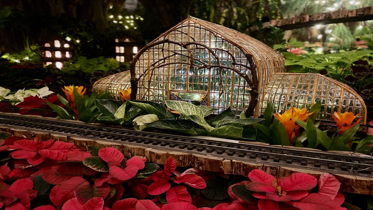 A replica of Krohn Conservatory constructed out of natural items like twigs and leaves. It's one of several models on display for the conservatory's Trains and Traditions winter show (Spectrum News/Casey Weldon)