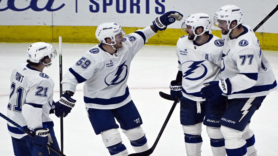 Tampa Bay Lightning right wing Nikita Kucherov, second from right, celebrates with teammates after scoring the winning goal during the overtime period of an NHL hockey game against the Chicago Blackhawks, Friday, Jan. 24, 2025, in Chicago. (AP Photo/Matt Marton)