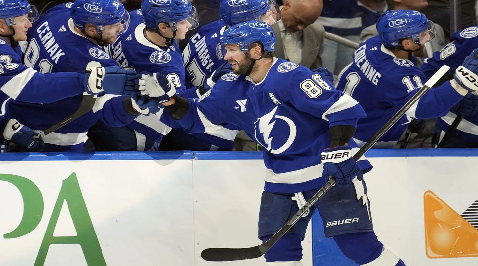 Tampa Bay Lightning right wing Nikita Kucherov (86) celebrates with the bench after scoring against the Vegas Golden Knights during the third period of an NHL hockey game Thursday, Oct. 17, 2024, in Tampa, Fla. (AP Photo/Chris O'Meara)