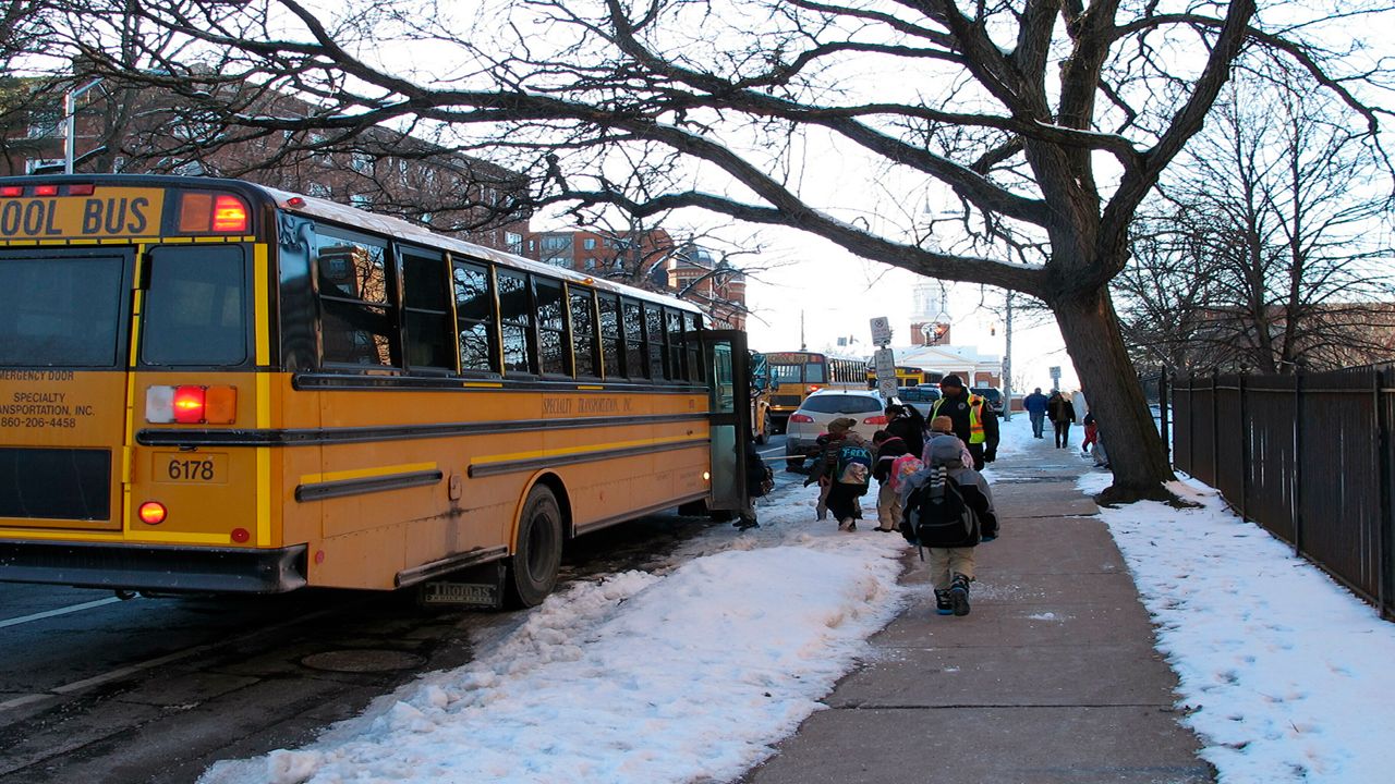Students board a bus after being dismissed from the Dr. Ramon Betances Elementary School in Hartford, Conn., on Thursday, Jan. 31, 2019.  (AP Photo/Dave Collins)