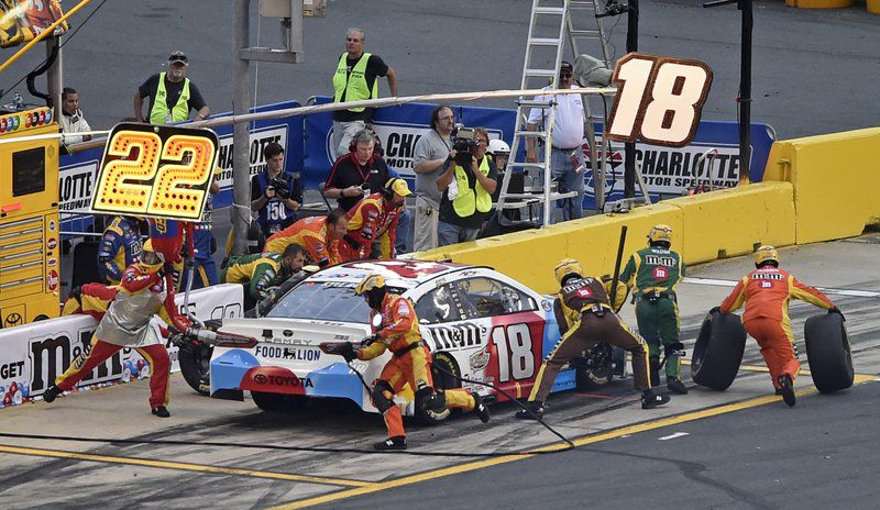 Crew members perform a pit stop on driver Kyle Busch’s car during the NASCAR Cup Series auto race at Charlotte Motor Speedway in Charlotte, N.C., Sunday, May 27, 2018. (AP Photo/Mike McCarn)