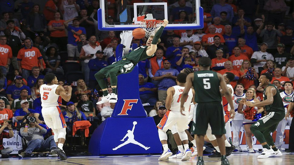 Kyle Ahrens scored Michigan State's final seven points and No. 10 Michigan beat Florida 63-59 on Saturday.