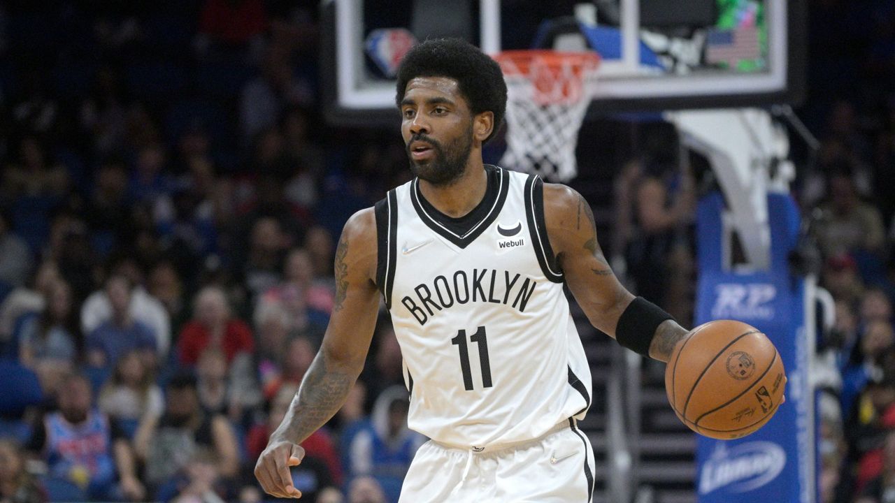 Brooklyn Nets guard Kyrie Irving (11) sets up a play during the first half of an NBA basketball game against the Orlando Magic, Tuesday, March 15, 2022, in Orlando, Fla. (AP Photo/Phelan M. Ebenhack)