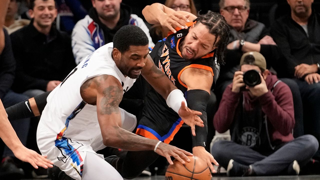 Kyrie Irving and Jalen Brunson fight for a loose ball on Saturday, Jan. 28, 2023 in New York.