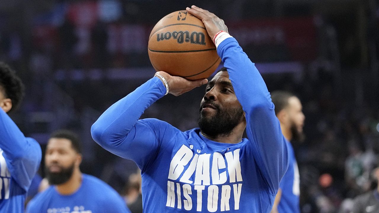 Dallas Mavericks guard Kyrie Irving smiles as he warms up prior to an NBA basketball game against the Los Angeles Clippers Wednesday, Feb. 8, 2023, in Los Angeles. (AP Photo/Mark J. Terrill)