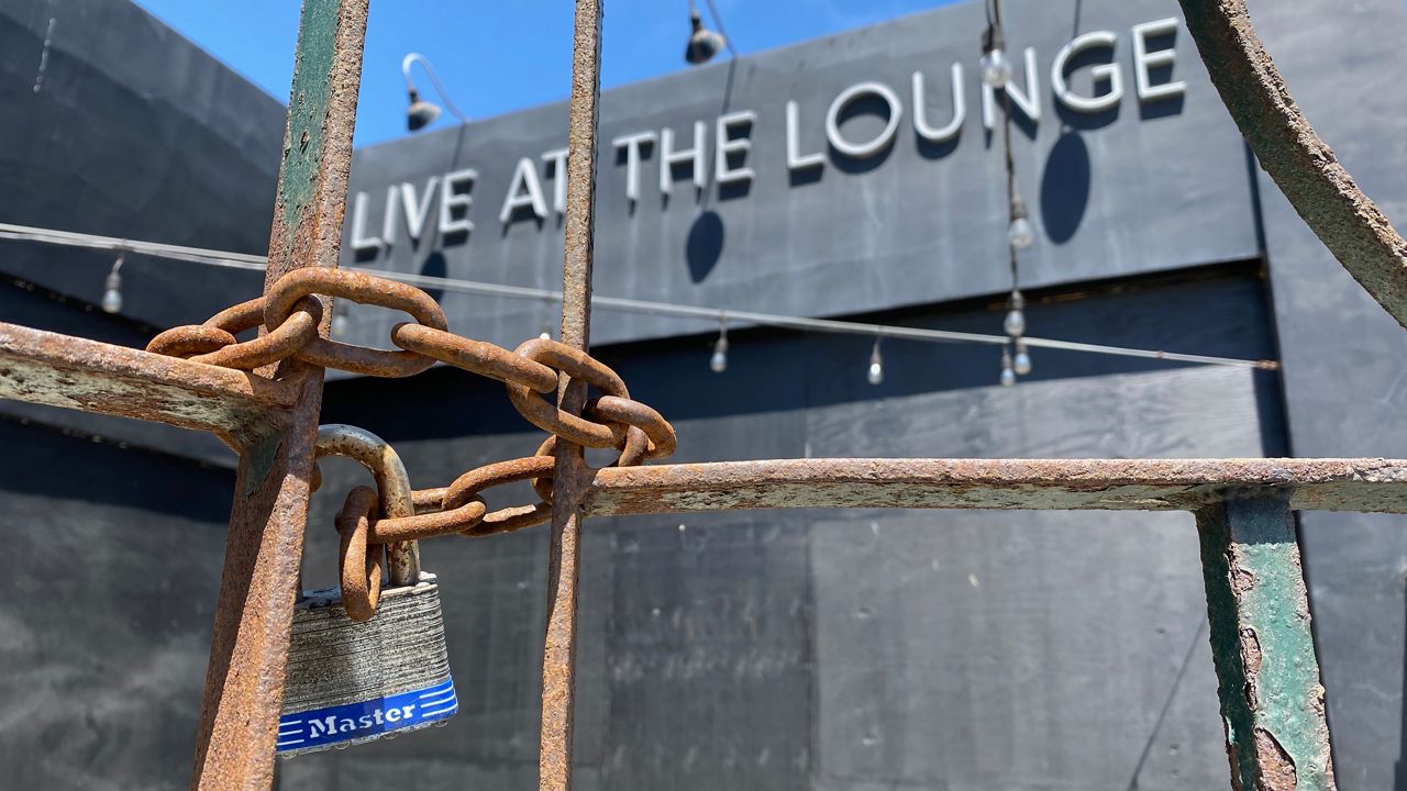 A locked gate blocks entry to Live at the Lounge, a side room to Hermosa Beach's Comedy and Magic Club (Spectrum News/David Mendez)