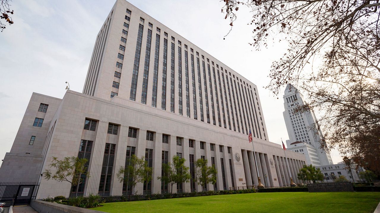 This Jan. 8, 2020 file photo shows the United States Court House building, known as Spring Street Courthouse, in downtown Los Angeles. Fear over spreading coronavirus cases has prompted a patchwork of reactions from California's courts, with some closing altogether and others delaying trials. Los Angeles City Hall is at right. (AP Photo/Damian 