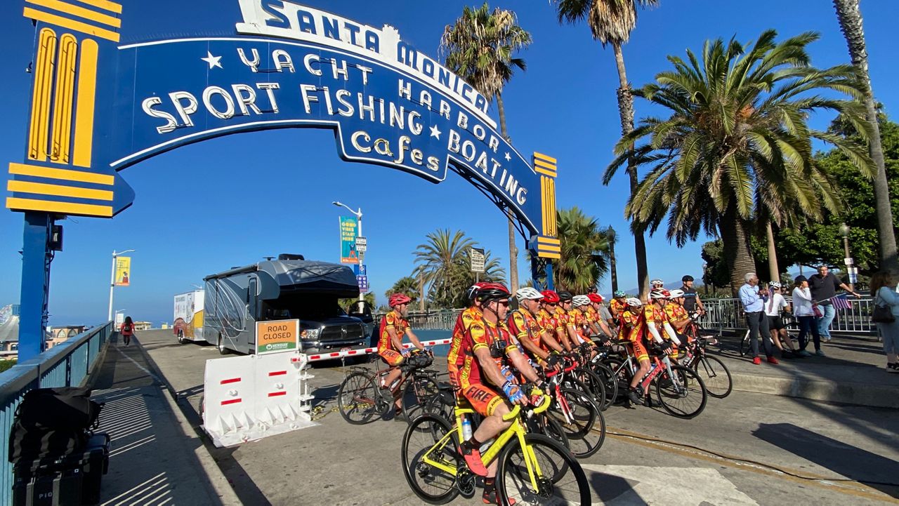 Fire Velo's riders get ready to launch from their starting line at the Santa Monica Pier on Sunday, Aug. 1. (Spectrum News/David Mendez)