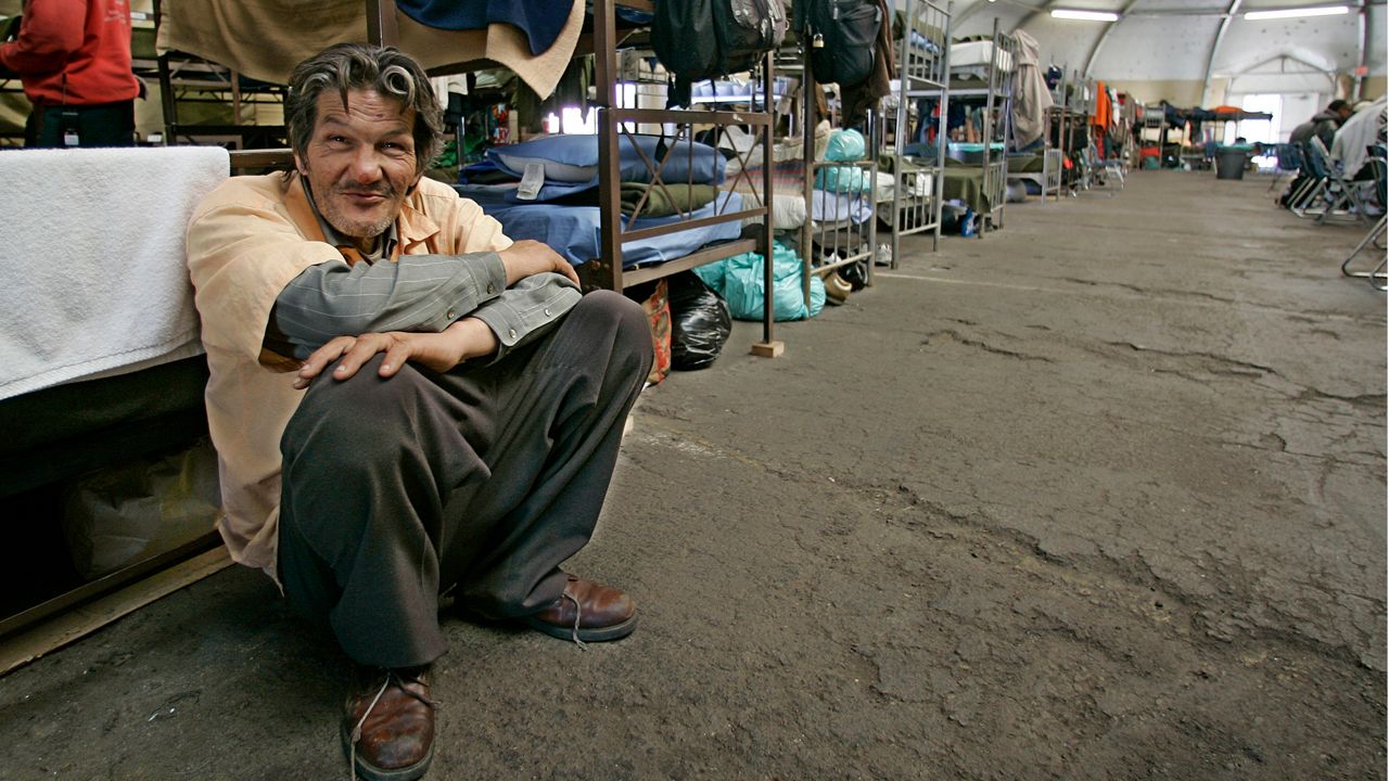 Daniel Machado, from Los Angeles and a Vietnam era veteran, leans against a bunk at a homeless shelter for veterans in San Diego, positioning himself to be at the front of the food line, Wednesday, March 28, 2007. (AP Photo/Lenny Ignelzi)