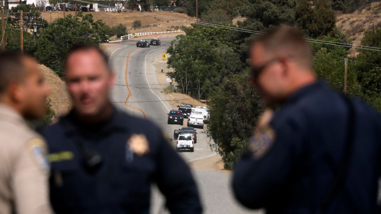 Law enforcement authorities close off a road during an investigation for a shooting at fire station 81 in Santa Clarita, Calif. on Tuesday, June 1, 2021.  (AP Photo/David Swanson)