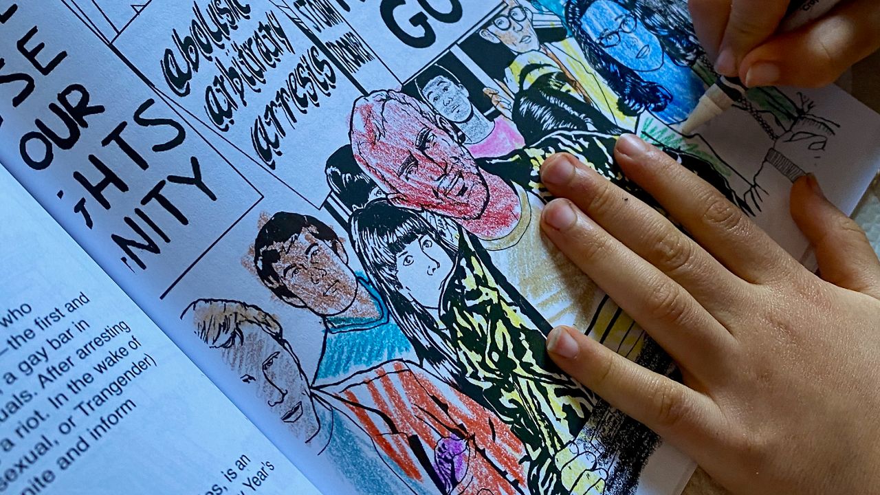 Young hands color an image of LGBT rights advocate Aristide Laurent in the pages of "Hidden Heroes, Historic Places," a coloring book benefitting the Los Angeles Public Library's Octavia Lab. (Photo courtesy LAPL)
