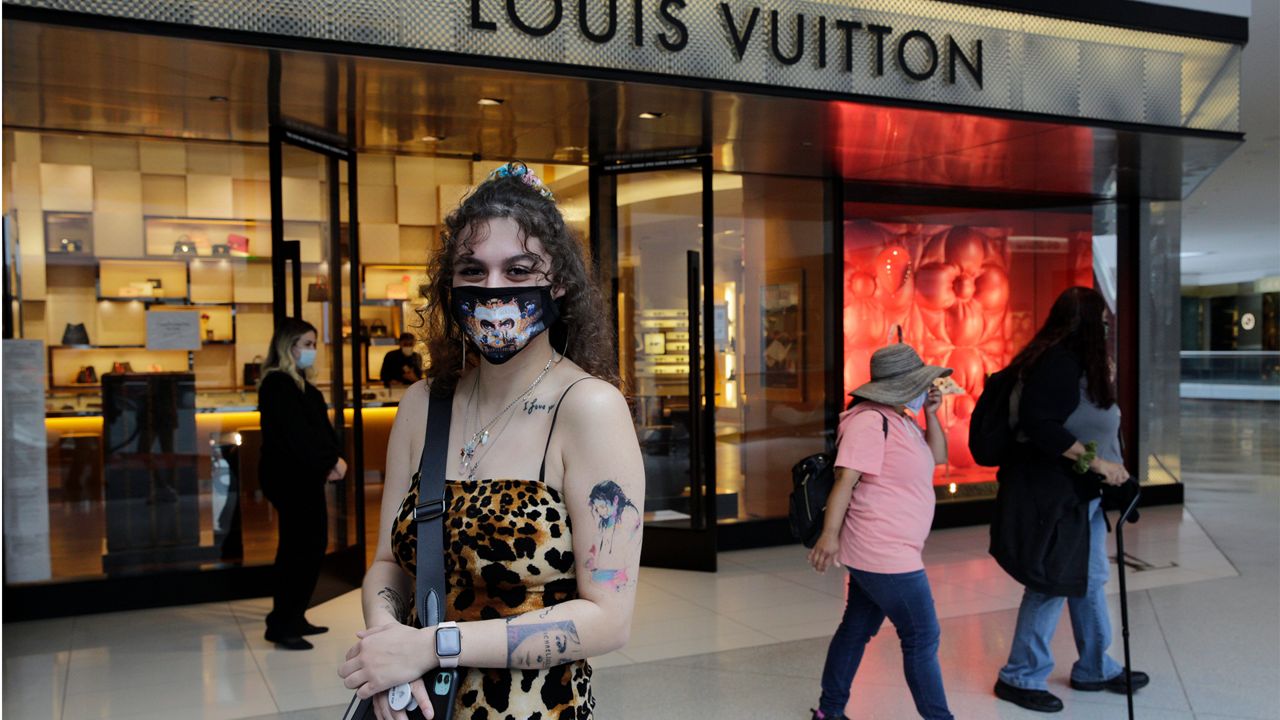 Singer Fallon Nicole, 23, left, shops at the Louis Vuitton boutique at the opening of Beverly Center shopping mall in Los Angeles, Friday, May 29, 2020. (AP Photo/Damian Dovarganes