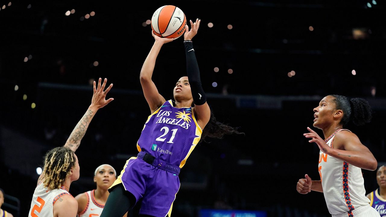 Los Angeles Sparks guard Jordin Canada, second from right, shoots as Connecticut Sun guard Natisha Hiedeman, left, guard DiJonai Carrington, second from left, and forward Alyssa Thomas defend during the first half of a WNBA basketball game Thursday, Aug. 11, 2022, in Los Angeles. (AP Photo/Mark J. Terrill)