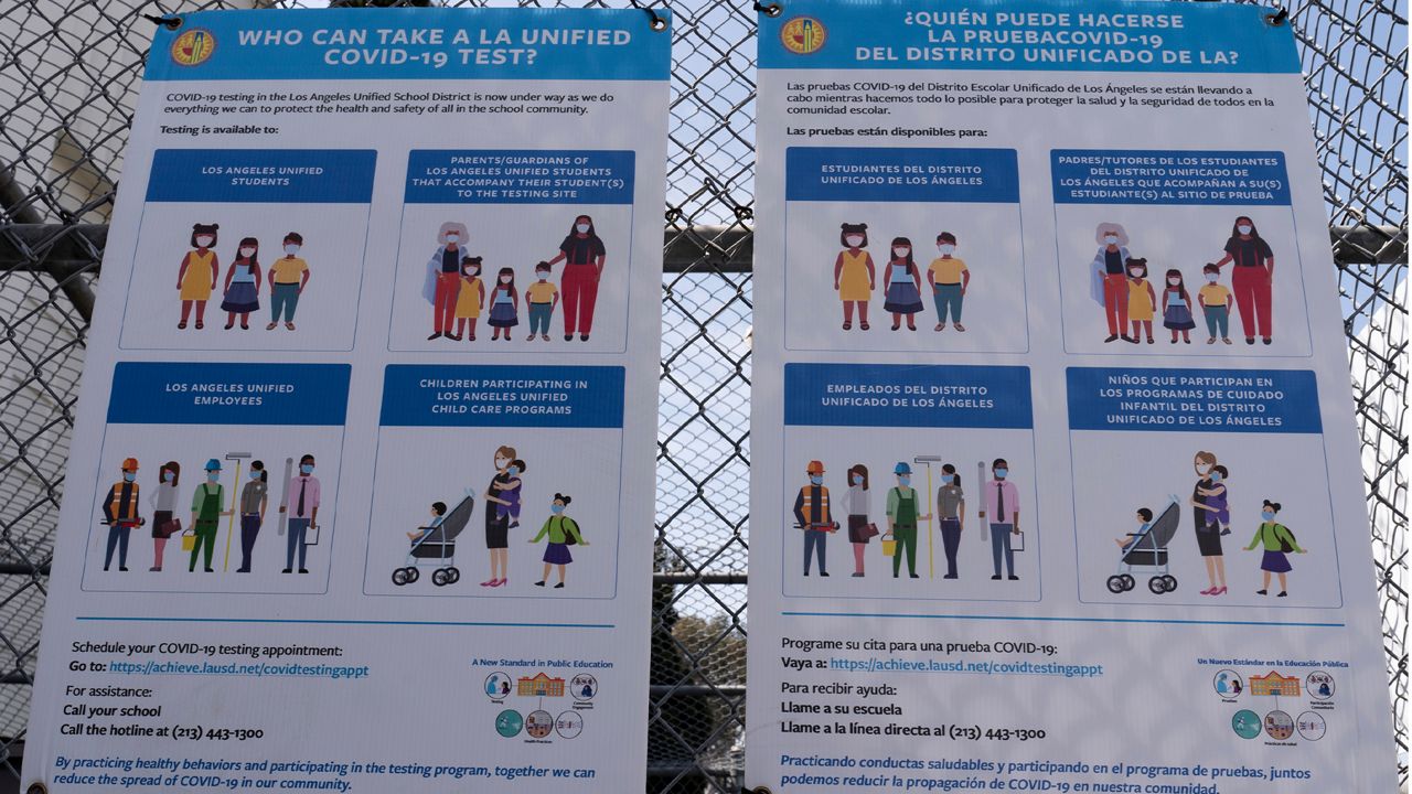 Los Angeles Unified School District, LAUSD instructions for eligibility for free COVID-19 tests provided for LAUSD community members are posted at a site run by the LAUSD in East Los Angeles Thursday, April 15, 2021. (AP Photo/Damian Dovarganes)