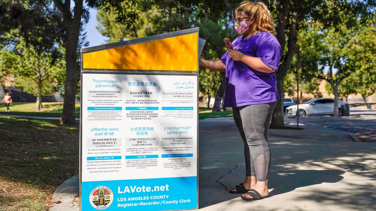 In this Oct. 14, 2020, file photo, a citizen drops her ballot at an official ballot drop box in Santa Clarita, Calif. (AP Photo/Marcio Jose Sanchez, File)