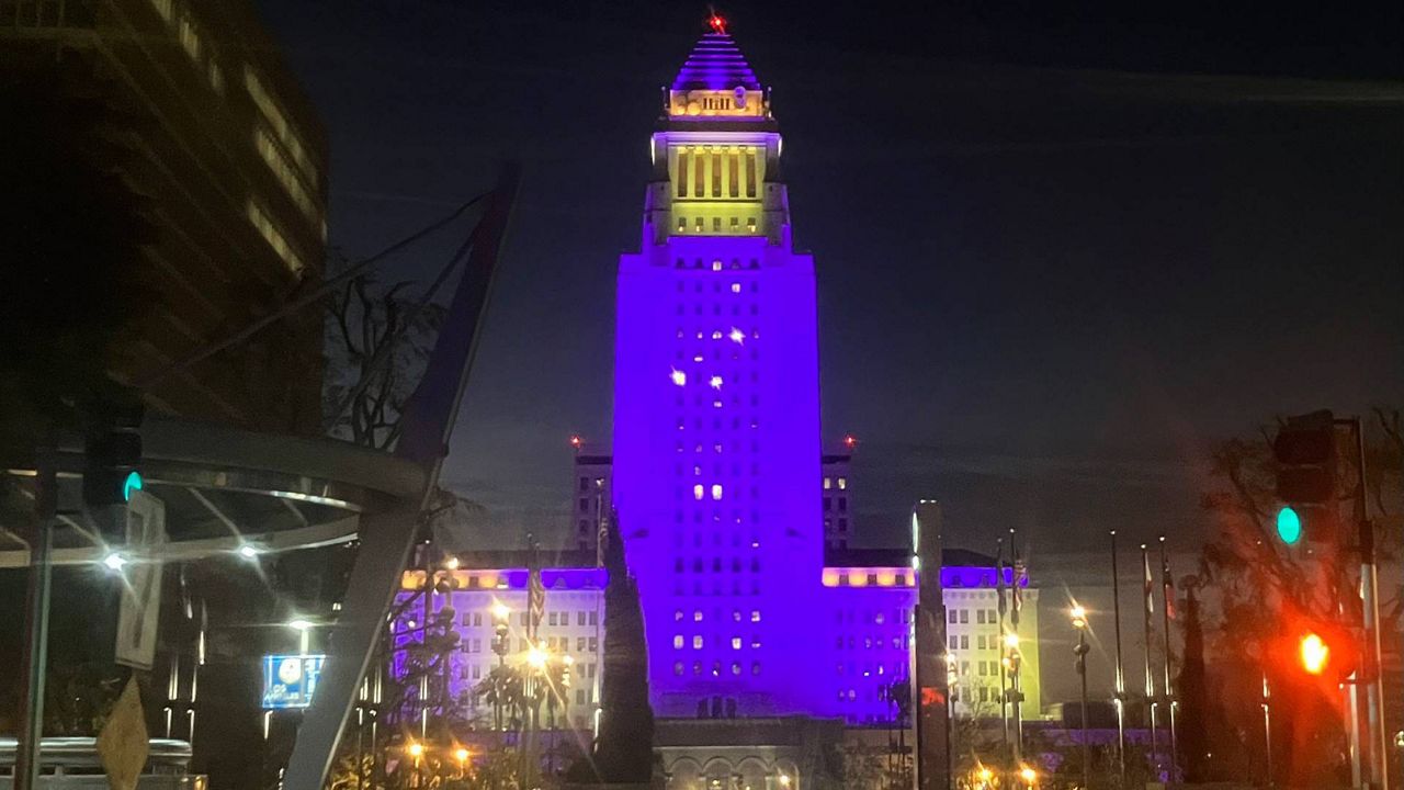Los Angeles City Hall is illuminated in the LA Lakers' purple and gold colors early Wednesday after LeBron James surpassed Kareem Abdul-Jabbar's NBA career scoring record. (AP Photo/John Antczak)