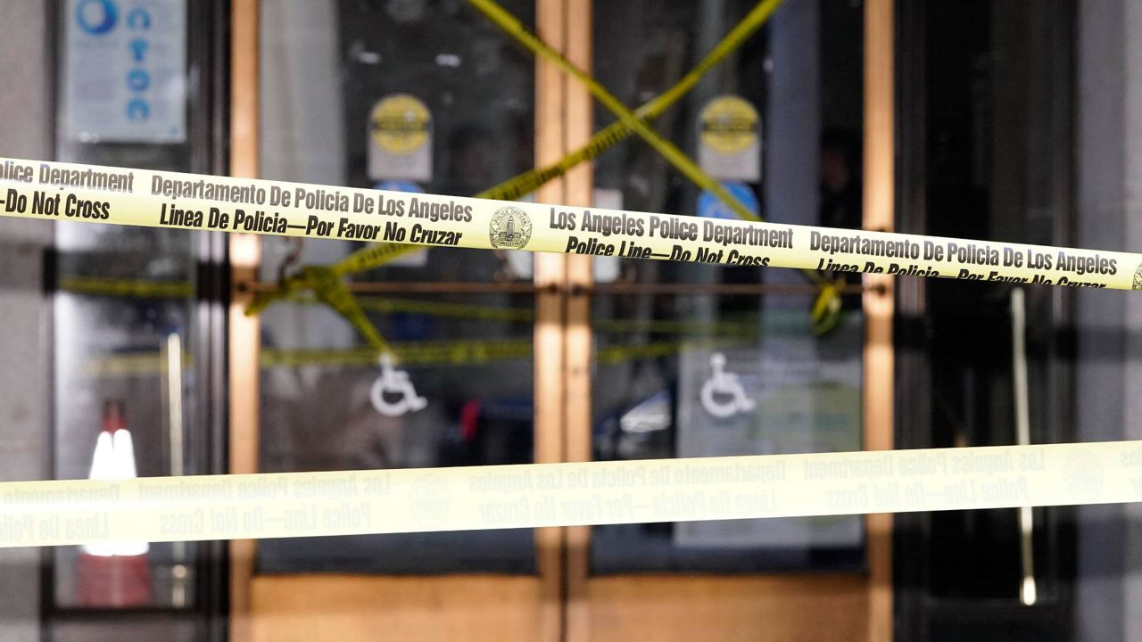 Police tape put up by protesters blocks the entrance of Los Angeles City Hall, Wednesday, Oct. 19, 2022, in Los Angeles. (AP Photo/Mark J. Terrill)