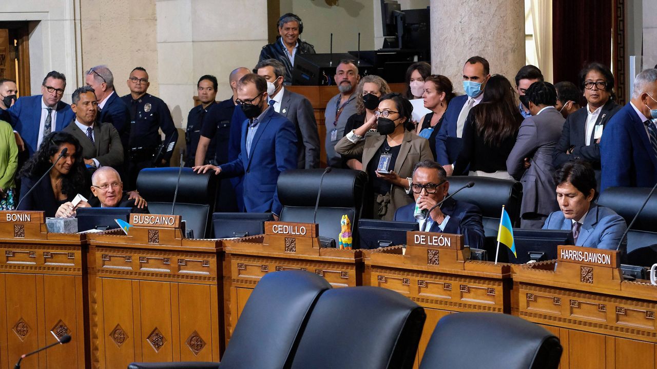 Los Angeles City Council member Mike Bonin, second from left, looks on as Council members Gil Cedillo, second from right, and Kevin de Leon, right, sit in chamber before starting the Los Angeles City Council meeting Tuesday, Oct. 11, 2022, in Los Angeles. (AP Photo/Ringo H.W. Chiu)