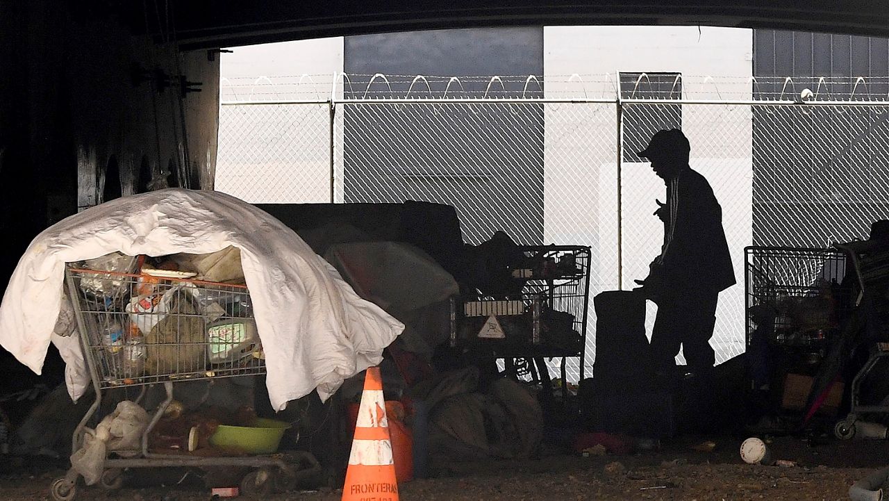 A man is seen at a homeless encampment that sits under Interstate 110 near Ramirez Street during the coronavirus outbreak in downtown Los Angeles on May 21, 2020. (AP Photo/Mark J. Terrill)