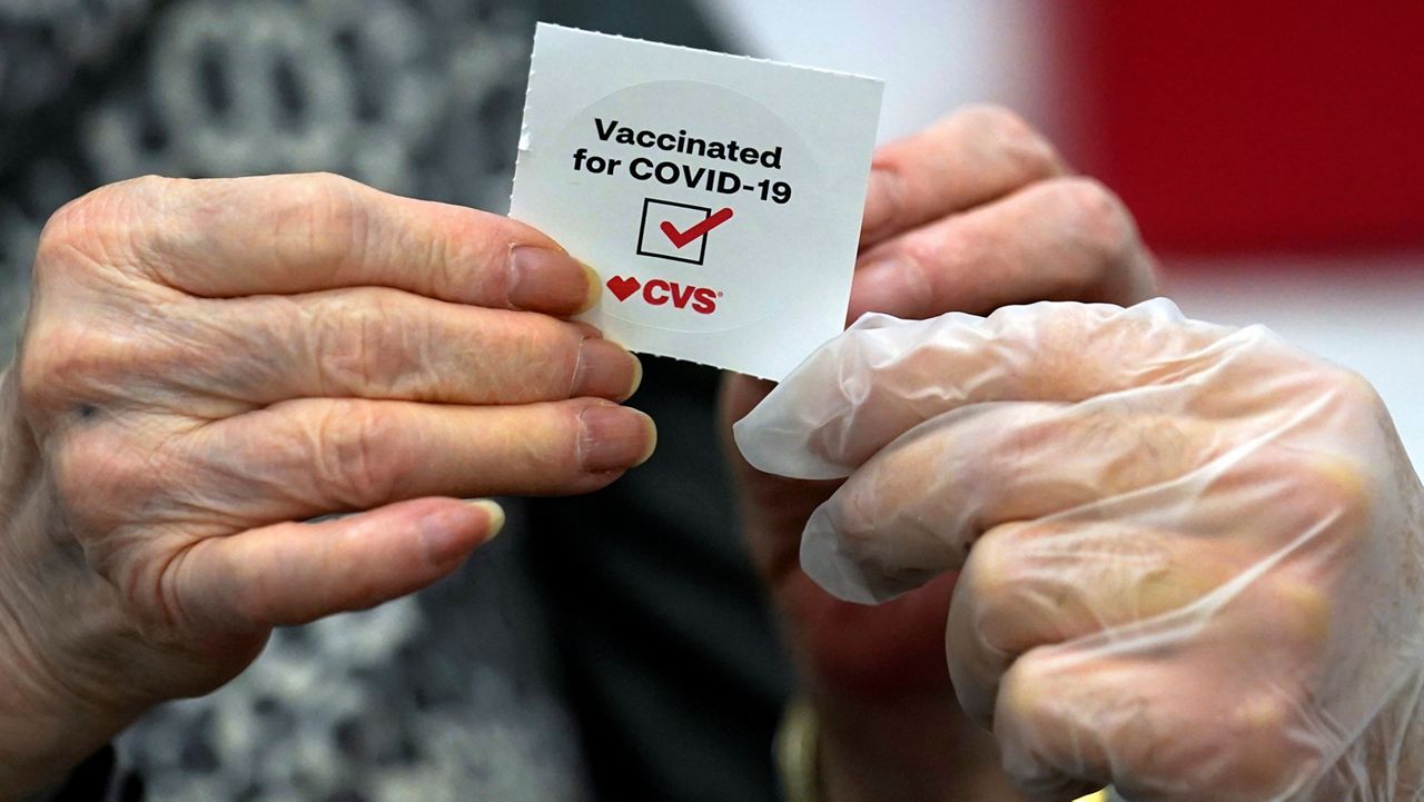 In this March 1, 2021, file photo, a patient receives a sticker after receiving a shot of the Moderna COVID-19 at a CVS Pharmacy branch in Los Angeles. (AP Photo/Marcio Jose Sanchez, File)