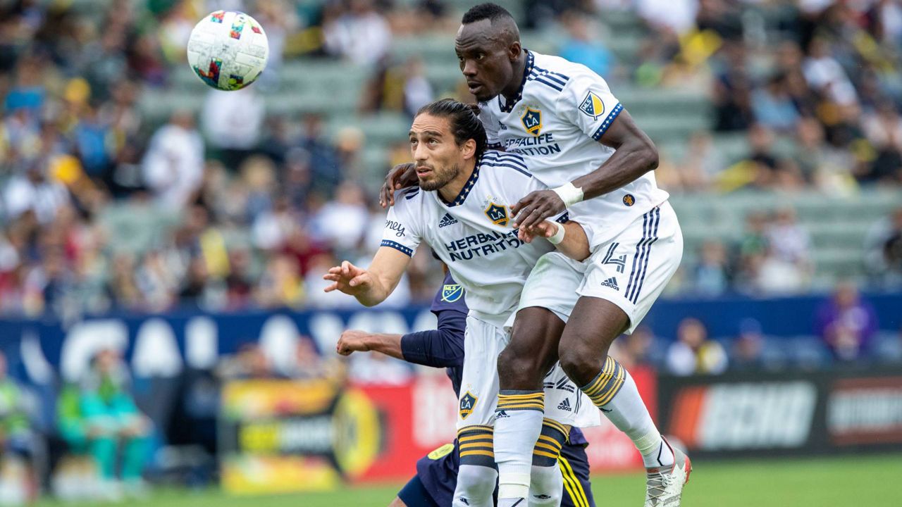 LA Galaxy defender Martin Caceres, left, and defender Sega Coulibaly, right, head the ball away from Nashville SC forward Teal Bunbury during the first half of an MLS playoff soccer match, in Carson, Calif., on Saturday. (AP Photo/Alex Gallardo)