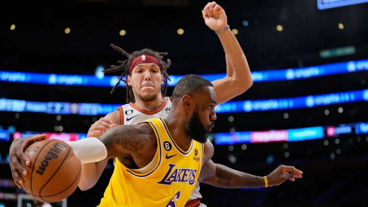 Los Angeles Lakers forward LeBron James (6) dribbles past Denver Nuggets forward Aaron Gordon in the first half of Game 4 of the NBA basketball Western Conference Final series Monday in LA. (AP Photo/Ashley Landis)