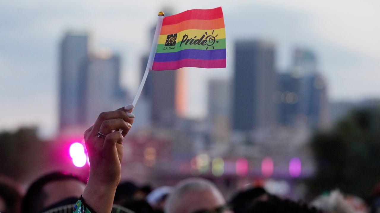 A pride flag is waved during the LA Pride in the Park festival at Los Angeles State Historic Park on Saturday. (AP Photo/Chris Pizzello)