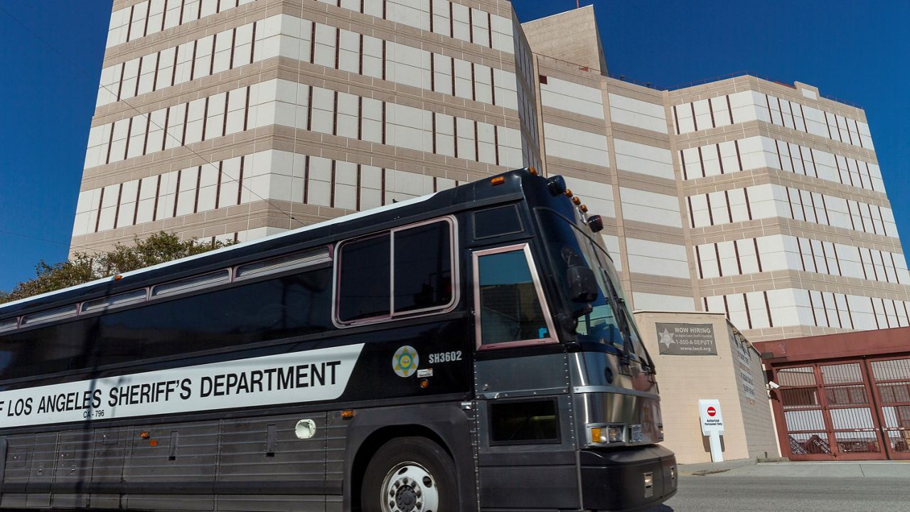 In this April 1, 2020 file photo a Los Angeles County Sheriff's Department prisoner transportation bus leaves the Twin Towers Correctional Facility in Los Angeles. (AP Photo/Damian Dovarganes, File)