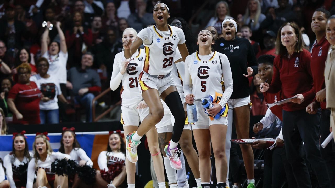 South Carolina forward Chloe Kitts (21), guard Bree Hall (23) and guard Tessa Johnson (5) react as their team scores against North Carolina during the first half of a second-round college basketball game in the women's NCAA Tournament in Columbia, S.C., Sunday, March 24, 2024. (AP Photo/Nell Redmond)