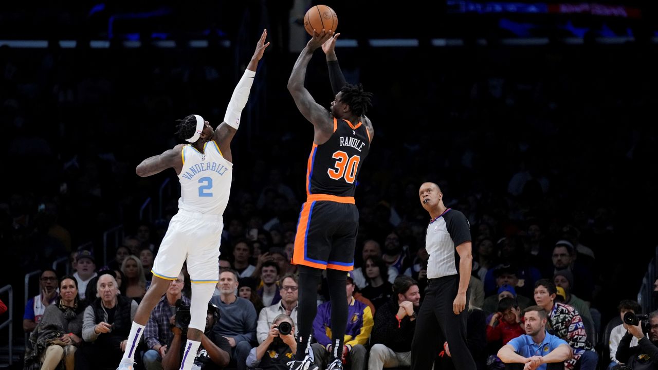 New York Knicks forward Julius Randle (30) shoots over Los Angeles Lakers forward Jarred Vanderbilt (2) during the first half of an NBA basketball game Sunday, March 12, 2023, in Los Angeles. (AP Photo/Marcio Jose Sanchez)