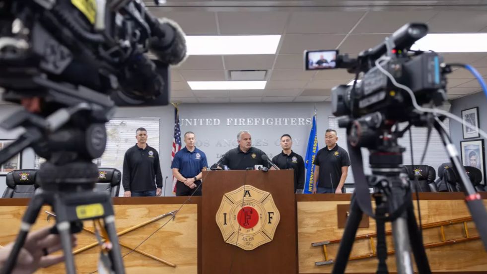 Freddy Escobar, center, was suspended from his post as president of United Firefighters of Los Angeles City. (Los Angeles Times/Myung J. Chun)