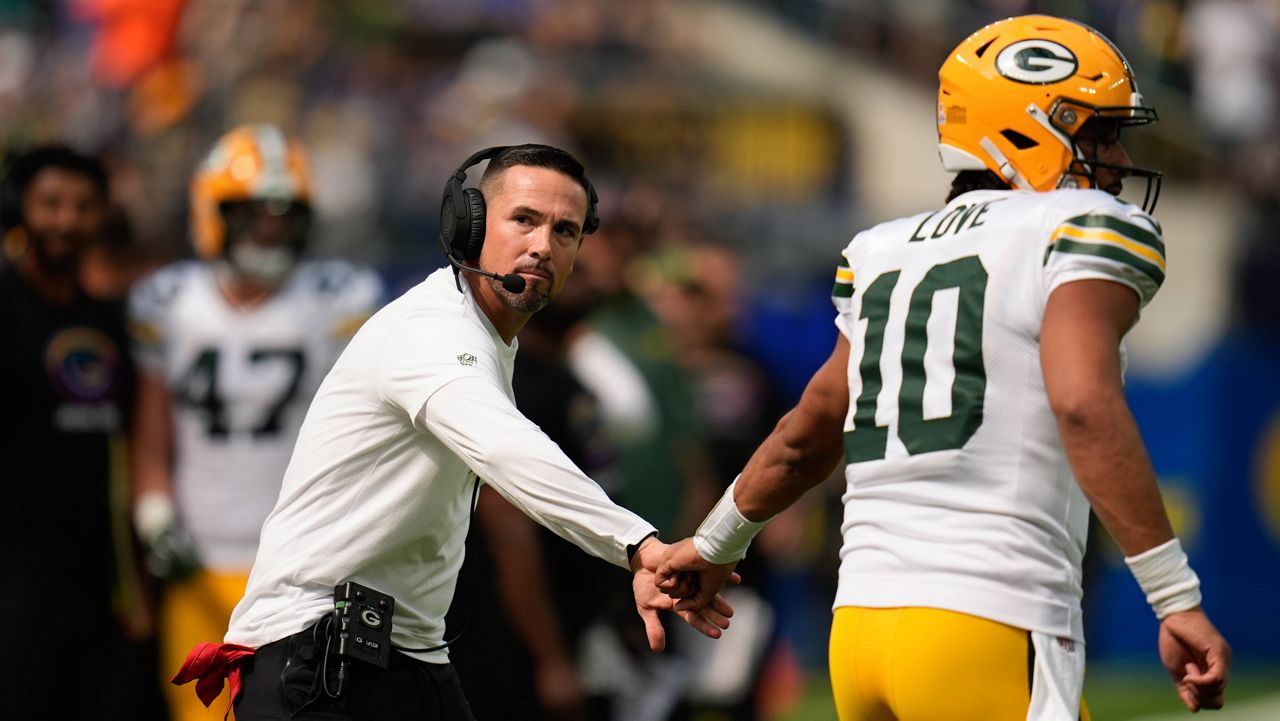 Green Bay Packers Head Coach Matt LaFleur, left, and quarterback Jordan Love (10) celebrates a touchdown