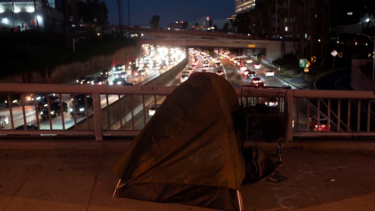 A homeless person's tent sits on a bridge over the 110 Freeway in Los Angeles, Wednesday, Dec. 14, 2022. (AP Photo/Jae C. Hong)