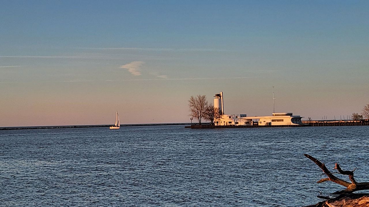 A sailboat moves toward the old Coast Guard station on Lake Erie in Cleveland on April 13, 2024. 